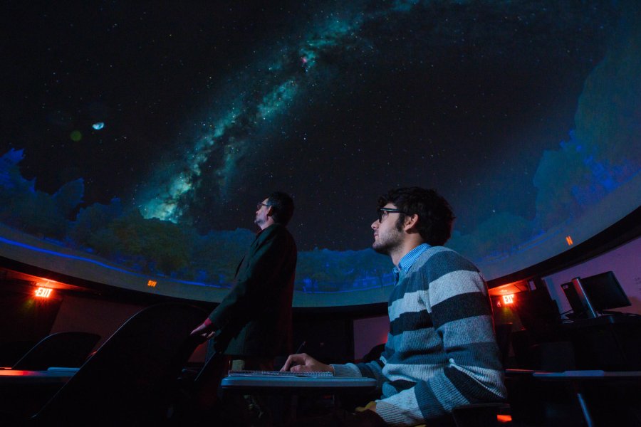 A student exploring the planetarium