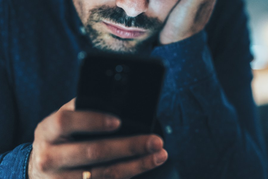 Man looking at his cell phone screen