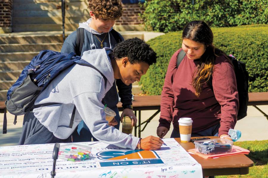 Student signing the It's On Us pledge