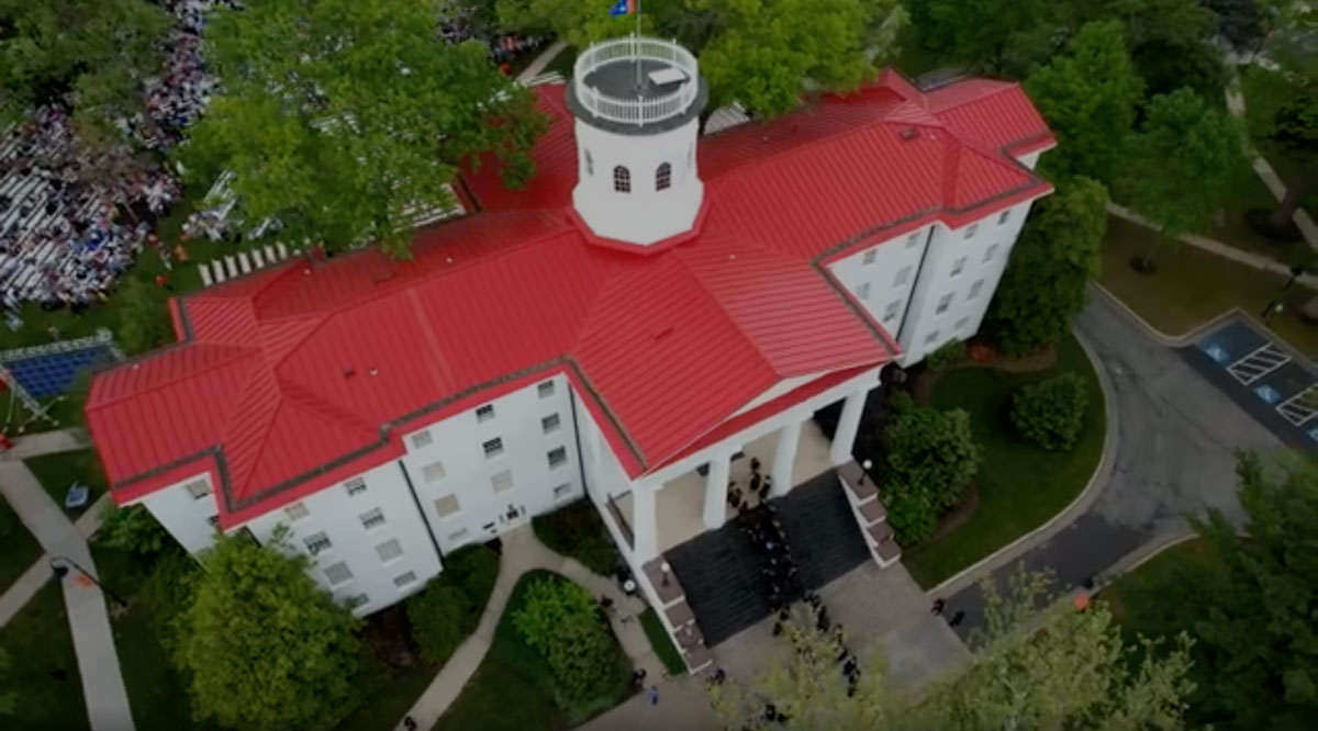 Aerial photo of Penn Hall with graduates walking into the building