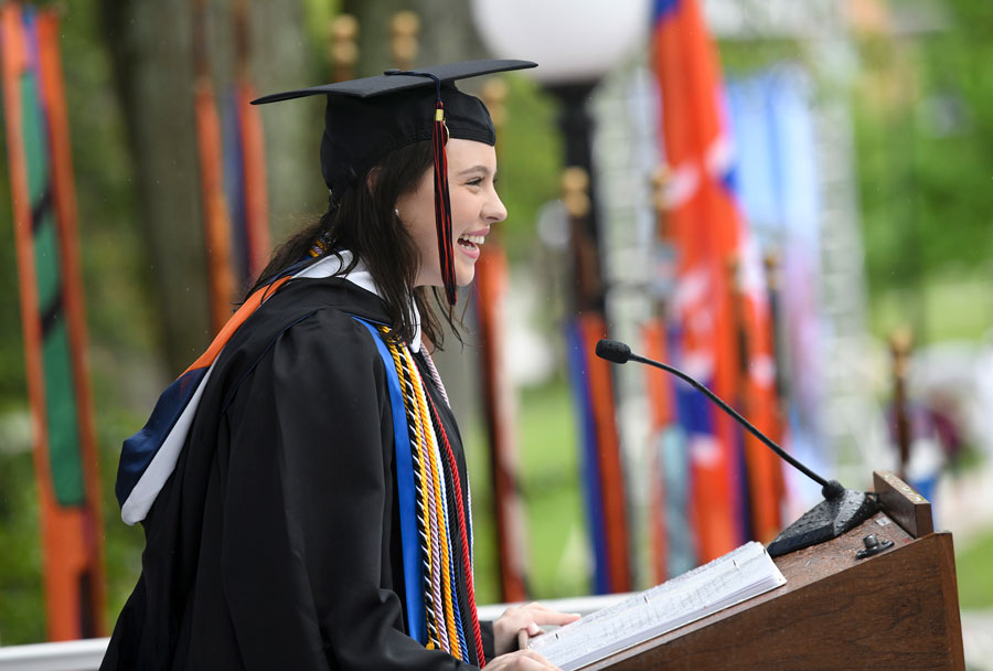 Phoebe Doscher speaking to a crowd of graduates