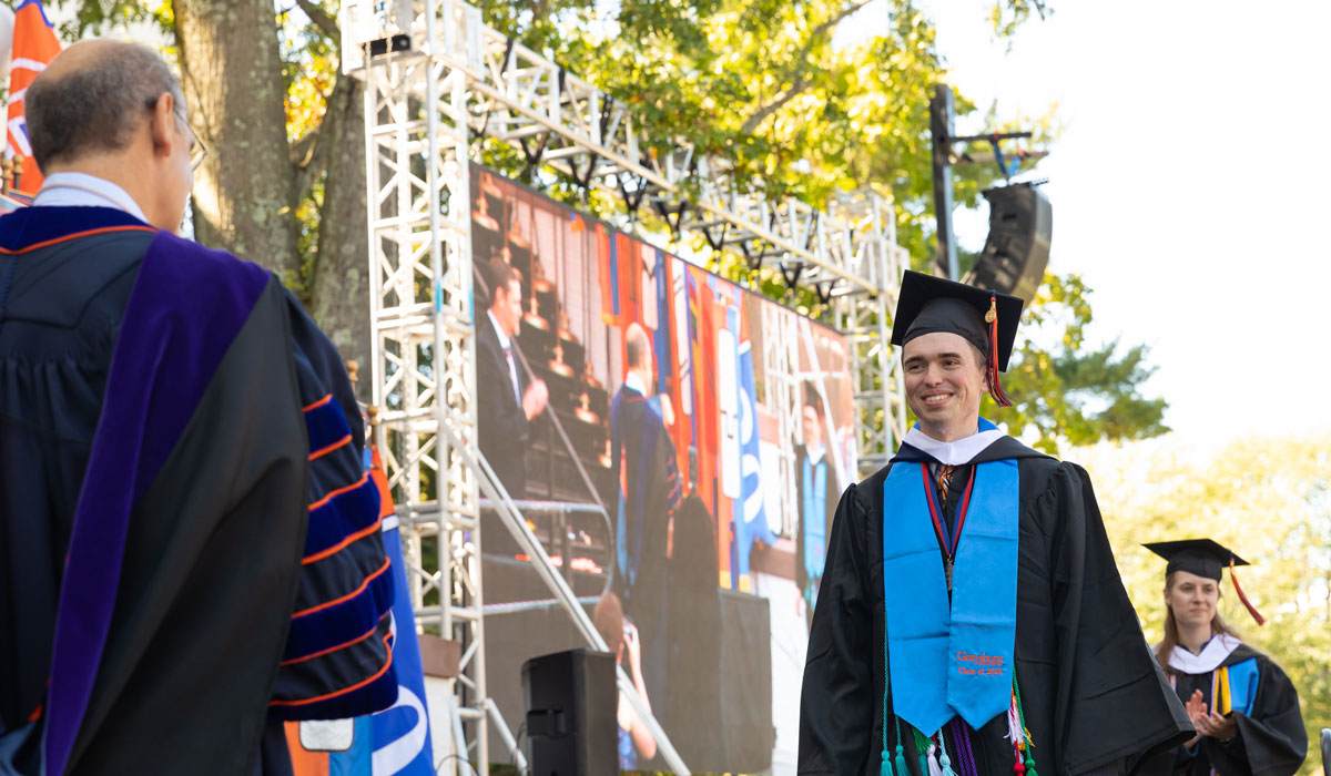 Ben Pontz receiving his degree at Commencement from President Bob Iuliano