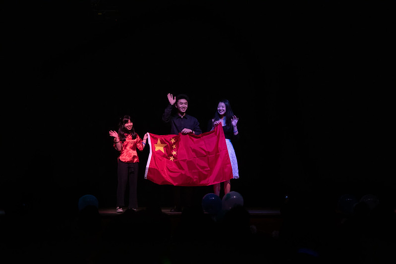 Two students holding China's flag