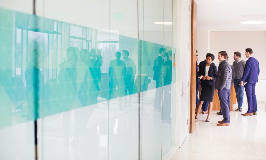 young professionals standing in front of the hallway