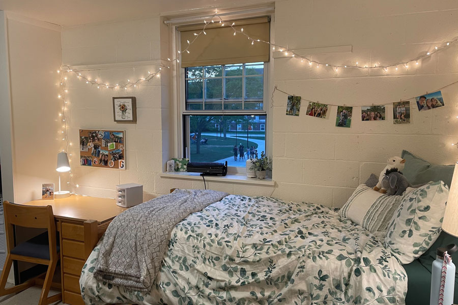 Bedroom with pendant lights and paintings.