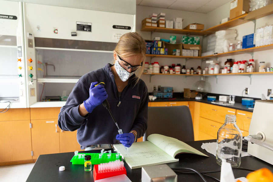 Female X-sig student assembling model cell membranes