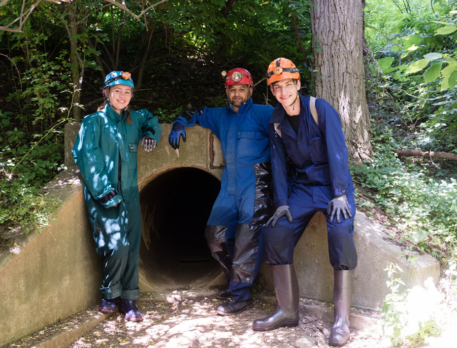 X-SIG students standing outside of a cave