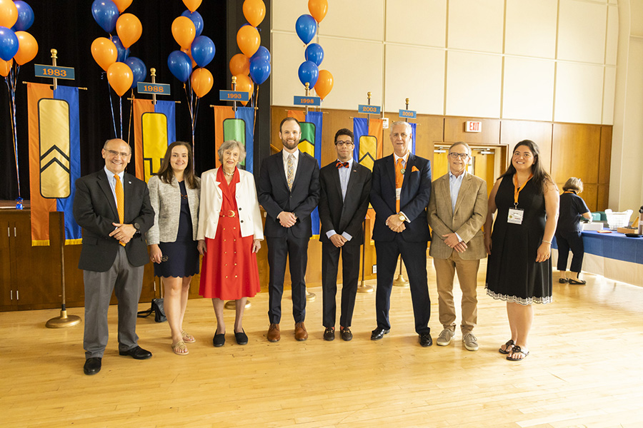 President Luliano alongside honored alumni