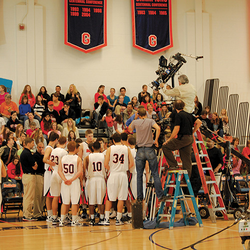 A packed crowd inside Bream Gym watches a scene