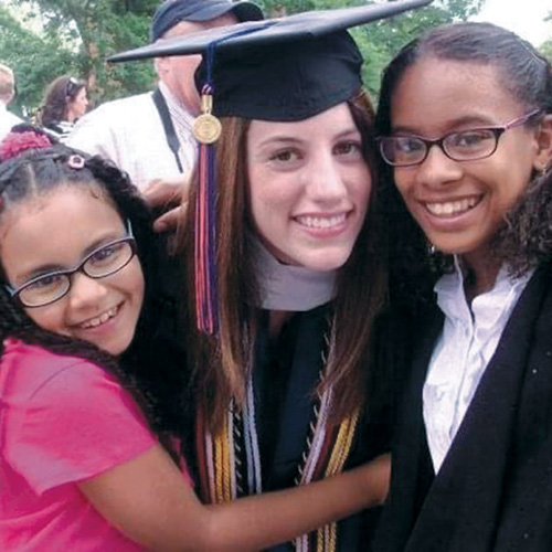 Rachel Rutter ’11 at Commencement with two El Centro kids