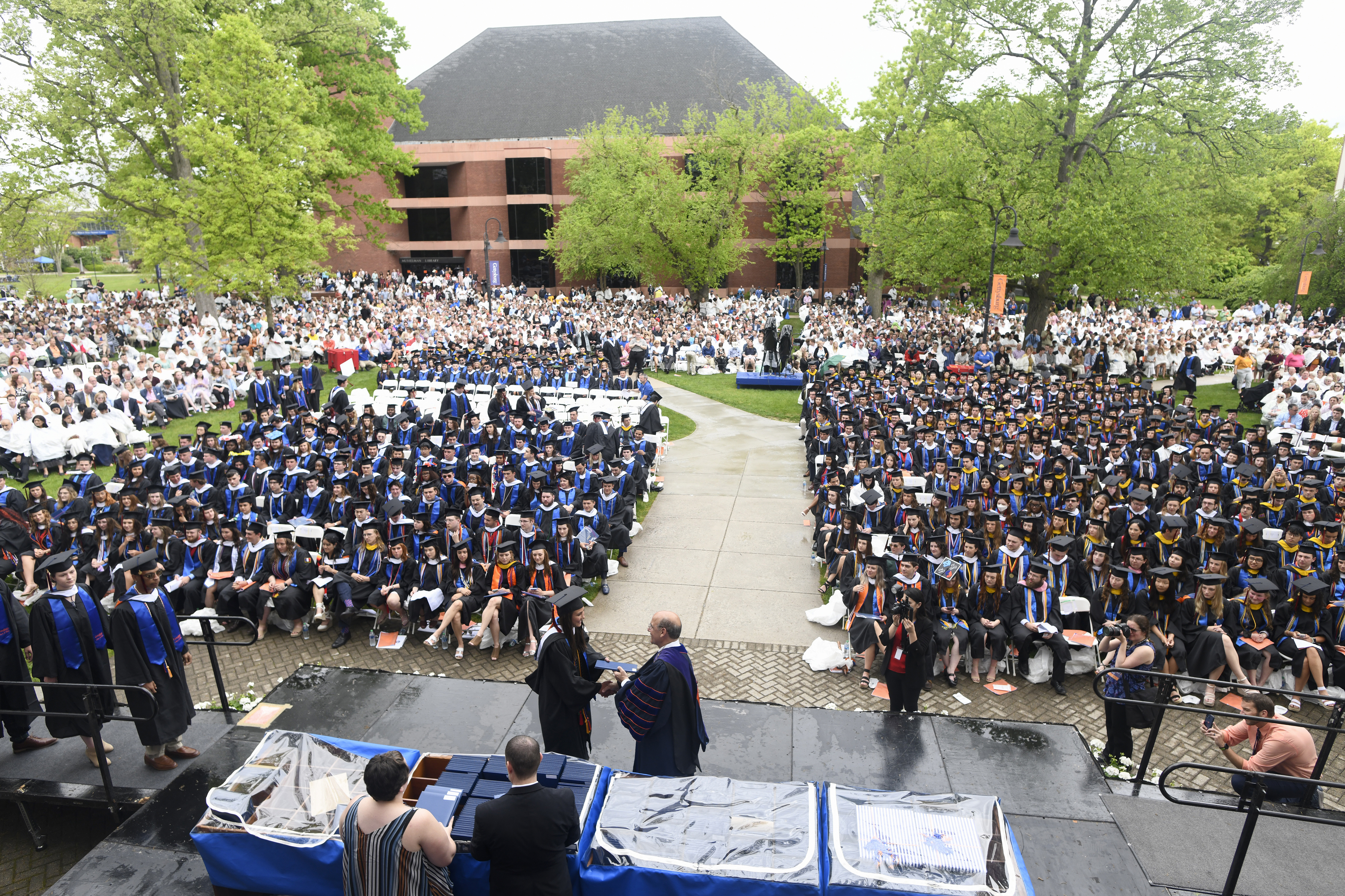Graduates, friends, and families at Commencement 