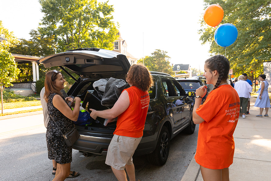 Volunteers help families unload vehicles