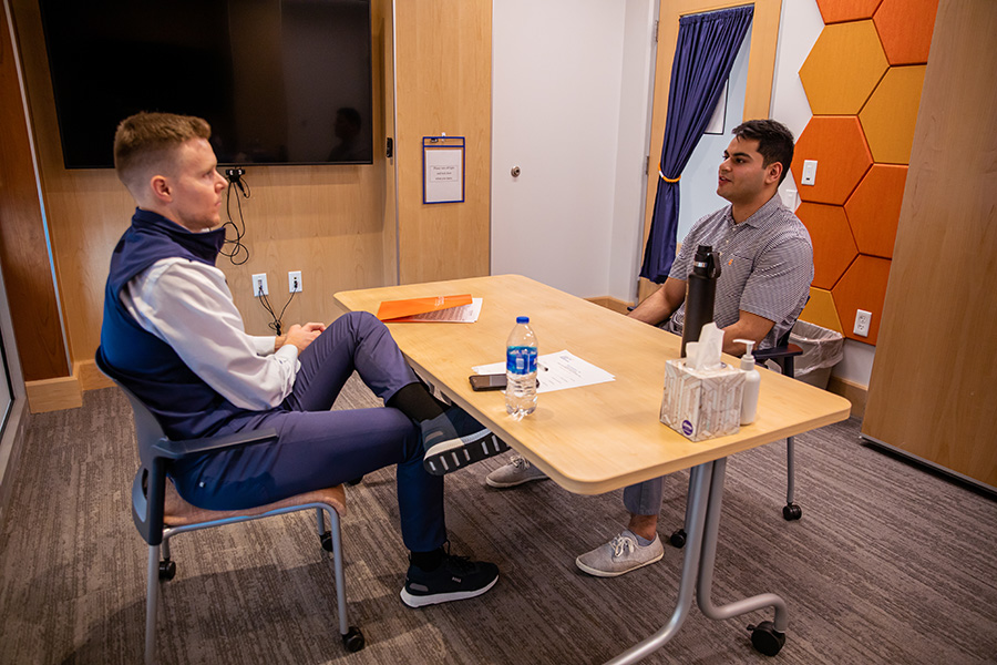 Richard Kampert talking to a student about finance