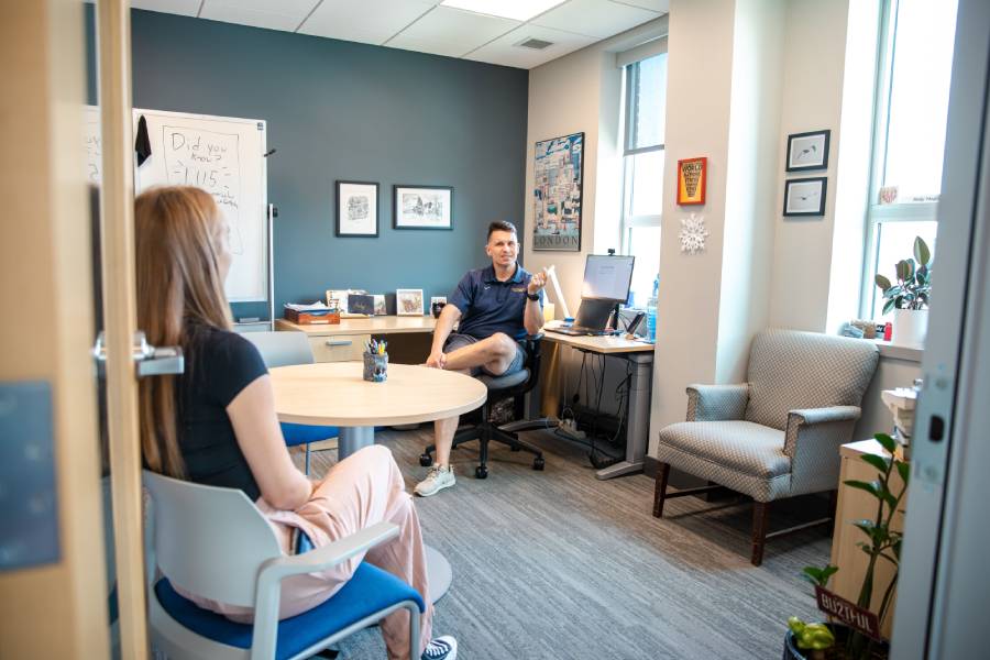 Andy speaking to a student  