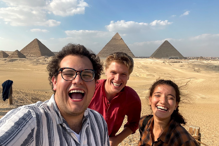 Brandon Neely with two people in front of pyramids