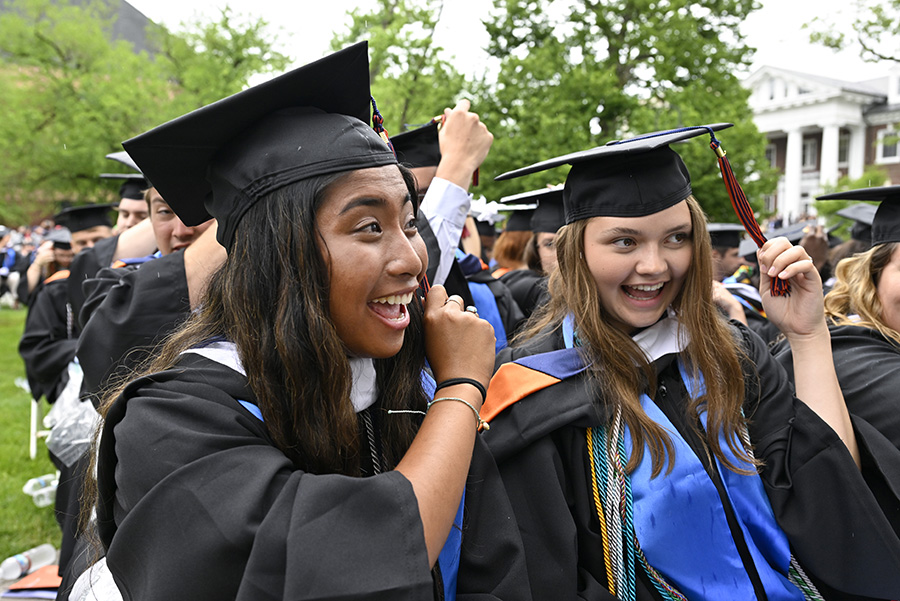 Two new graduates smiling