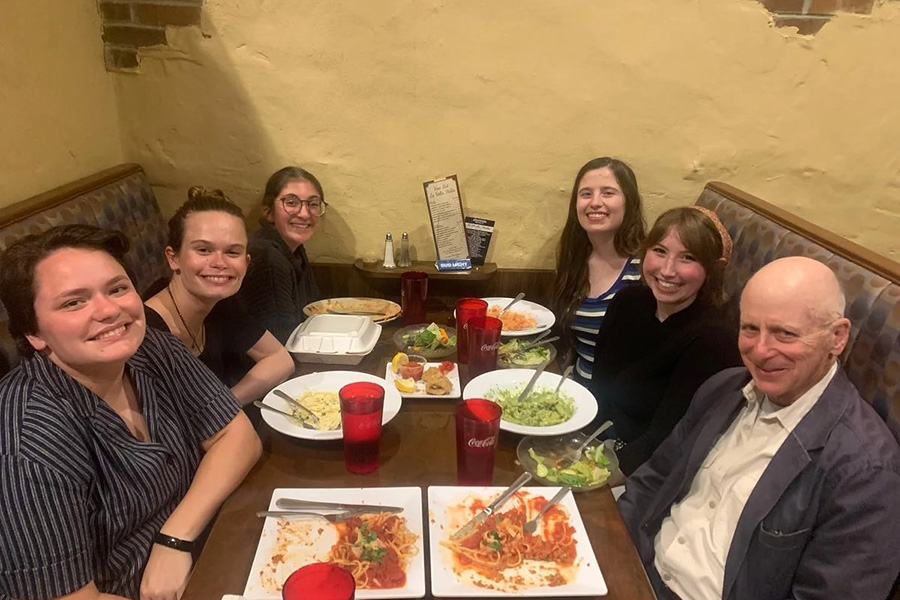 Radin shares a meal with alums and students in the fall of 2022