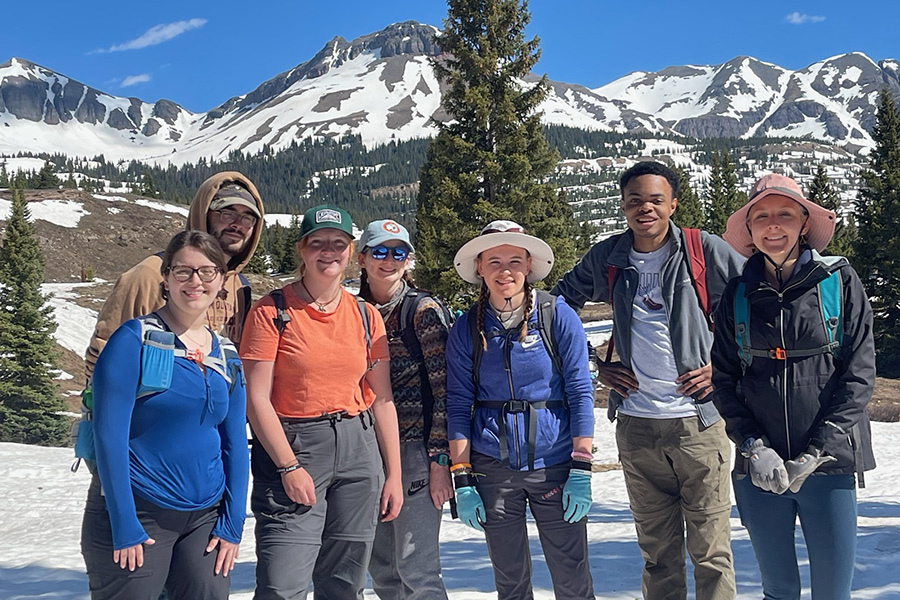 Students take a group photo at the Rocky mountains