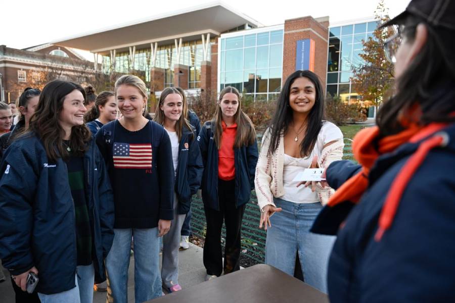 A photo of students receiving their table numbers
