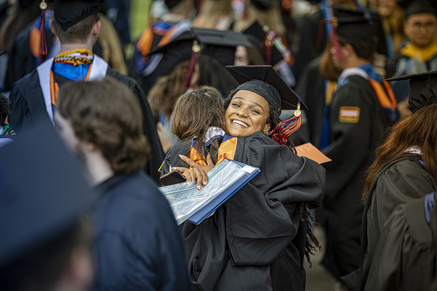 A pair of graduates greeting each other