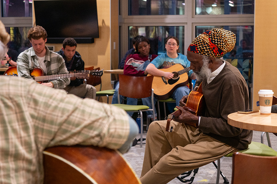 Harris leads a guitar workshop