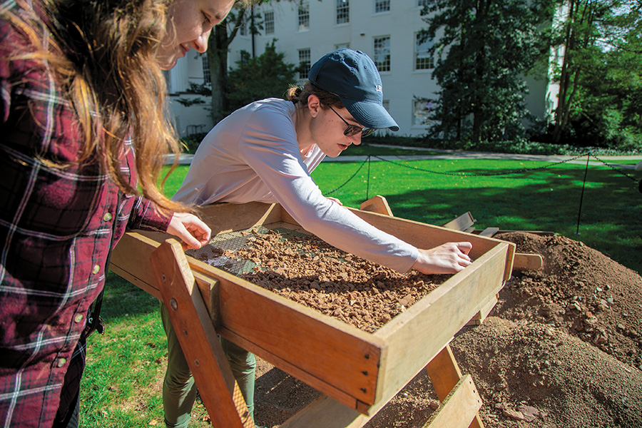 Astudent digging through in search of artifacts