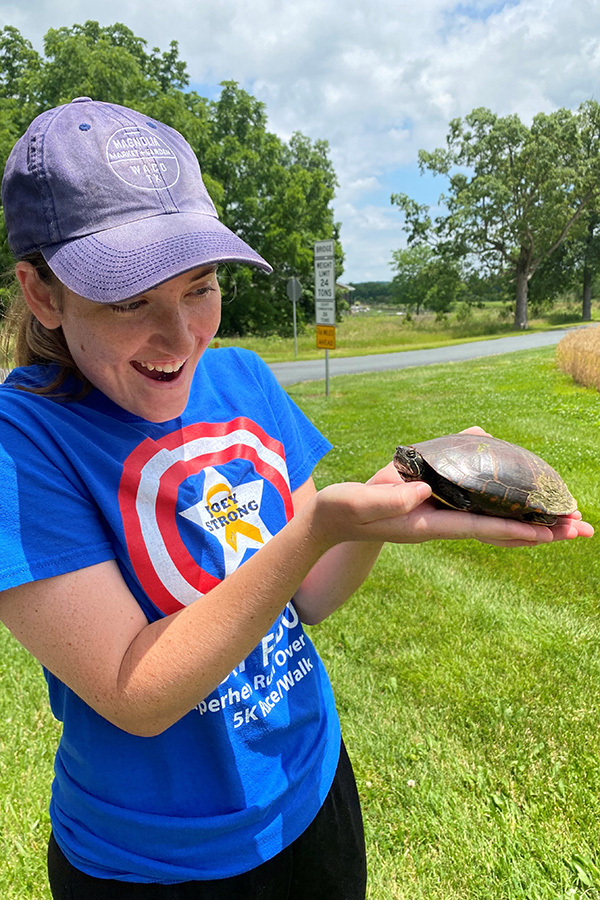 Molly Hoffman holds a painted turtle