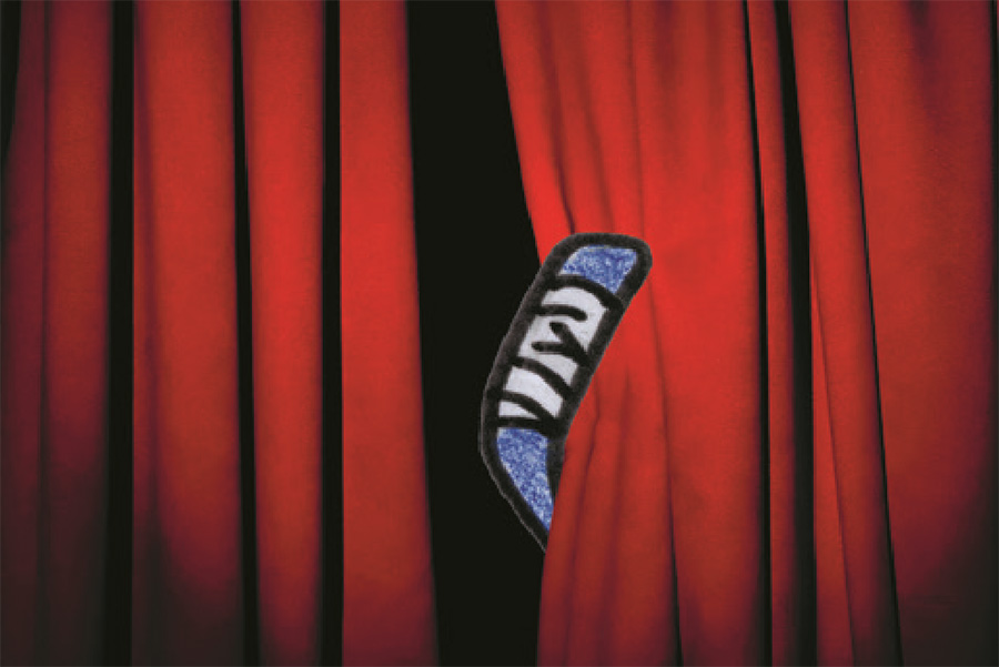 Red curtains slightly parted with a hockey stick