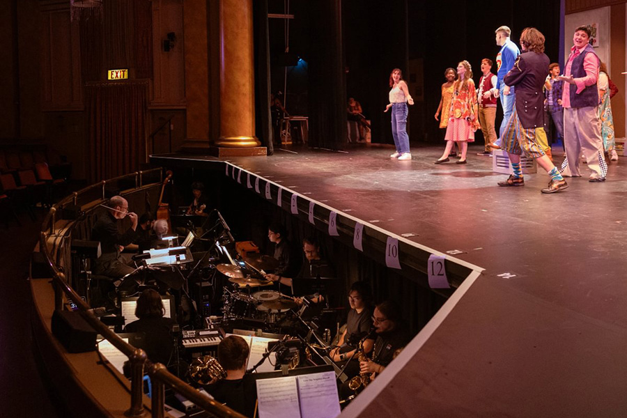 McCutcheon directs the pit orchestra