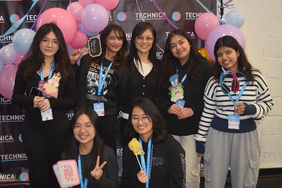 A group of students join Computer Science Chair Sunghee Sunny Kim after they won the Best Financial Hack award during Technica