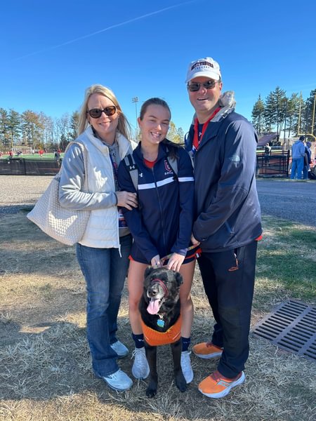 Ashley and Alan Zapata P’27 with their daughter Libby ’27 and dog Hamilton after a women’s soccer game