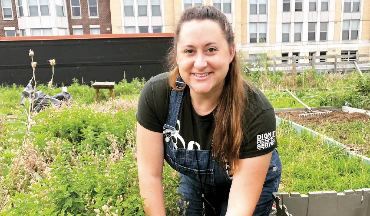 Ashley Domm ’07 works in Bread for the City’s rooftop garden.