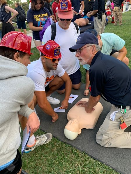 Officer Ed teaches students how to perform CPR.