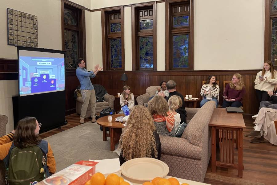 Prof. Lambert applauds Kahoot winner at Winterfest 2024.
