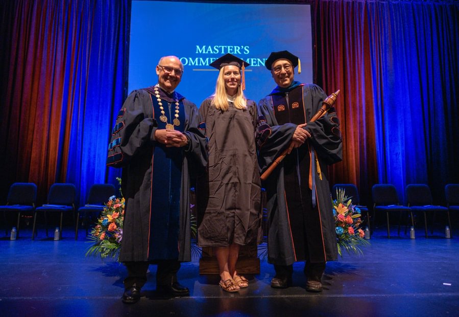 Gettysburg President Bob Iuliano, Lauren Bozart ’04, M’25, and History Prof. Michael Birkner ’72, P’10 stand on the Majestic Theater stage. 
