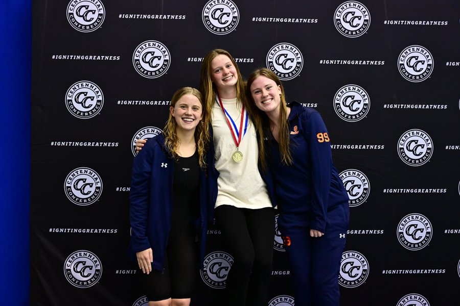 Paige McKim ’27, Ava Berry ’27, and Caitlyn Evans ’28 on the podium at the Centennial Conference women’s swimming championships.