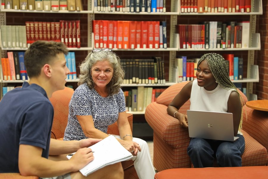 Fatou Ndiaye ’27 and Josh Herr ’28 meet with Prof. Anne Douds at Musselman Library.