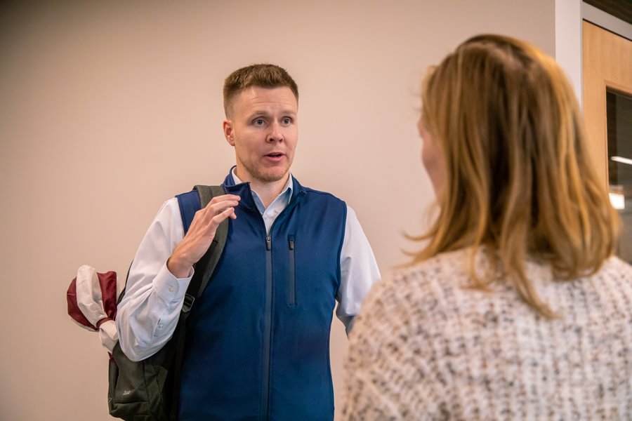 Richard Kampert speaking to a student