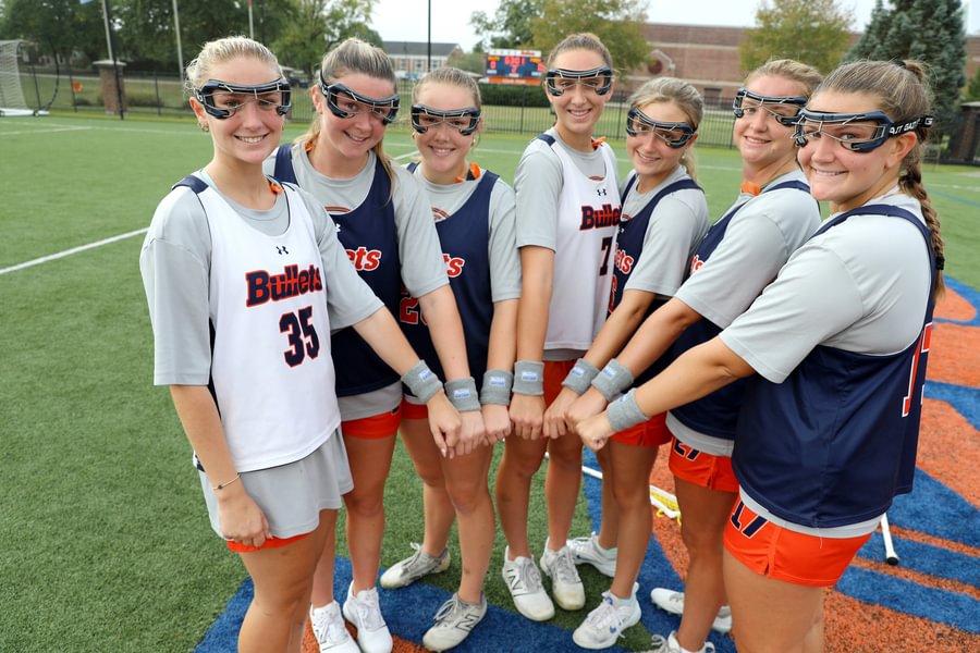 Women’s lacrosse Class of 2028 players show wristbands with Sadie Mauro’s initials.