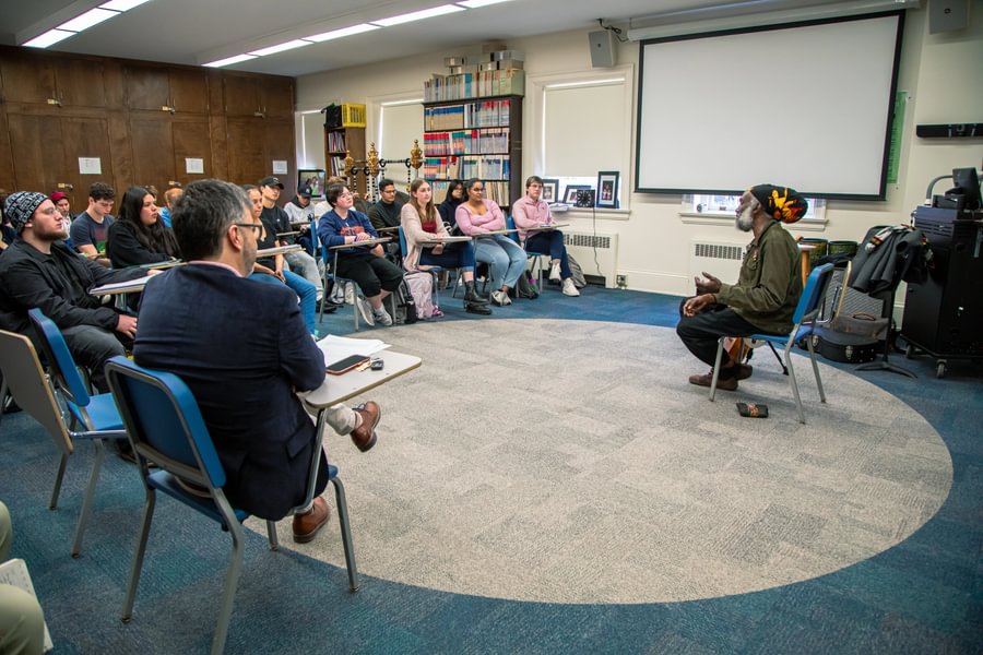 Africana Studies students participate in an interactive campus event featuring blues musician Corey Harris in 2024, organized in collaboration with academic departments.