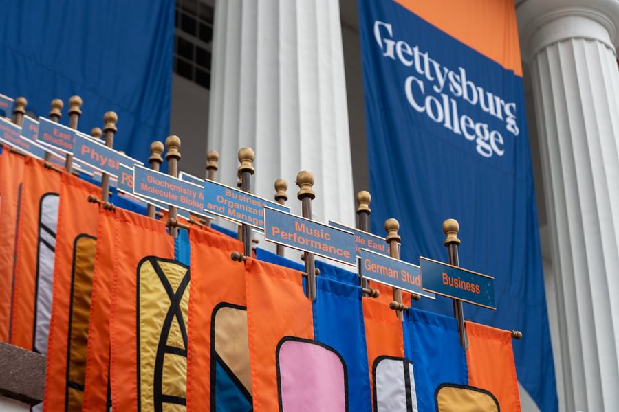 A student and professor reviewing notes together in a science lab