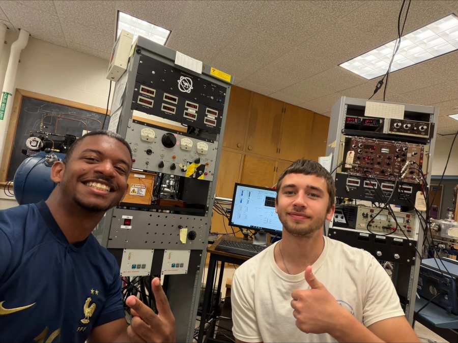 Christian Brutus ’27 and Hayden Matthew Fermier ’28 work with proton accelerator equipment during X-SIG research.
