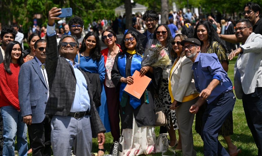 Graduates celebrate with family and friends following Commencement..