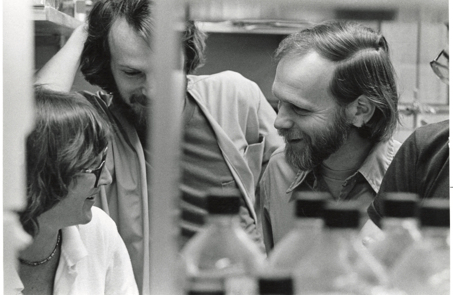 Michael Bishop ’57, 1989 Nobel Prize winner talking with friends.