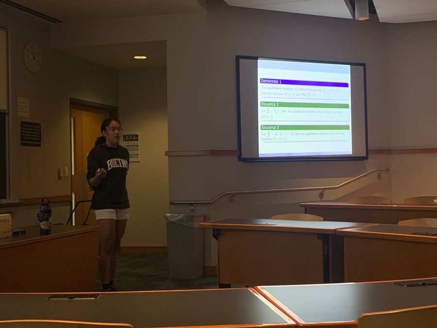 Sophie Nasir ’25 practices her summer research presentation on mathematical modeling with Prof. Kim Spayd.