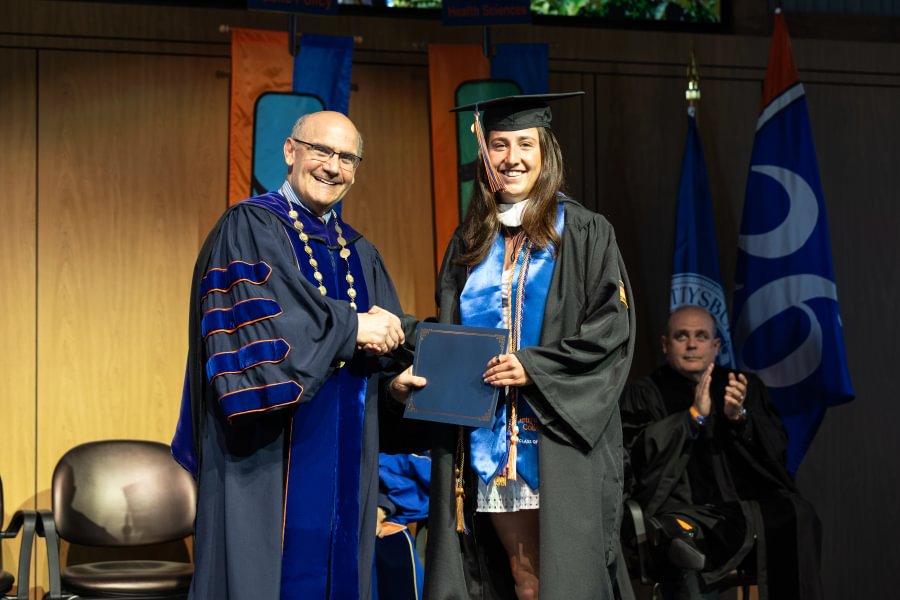 President Bob Iuliano congratulates Maddie Passarello ’26, a business, organizations, and management major from West Chester, Pennsylvania. 