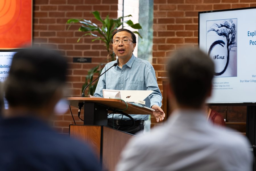  East Asian Studies Prof. Junjie Luo, director of the Johnson Center for Creative Teaching and Learning, greets attendees of the Summer Pedagogy Institute.