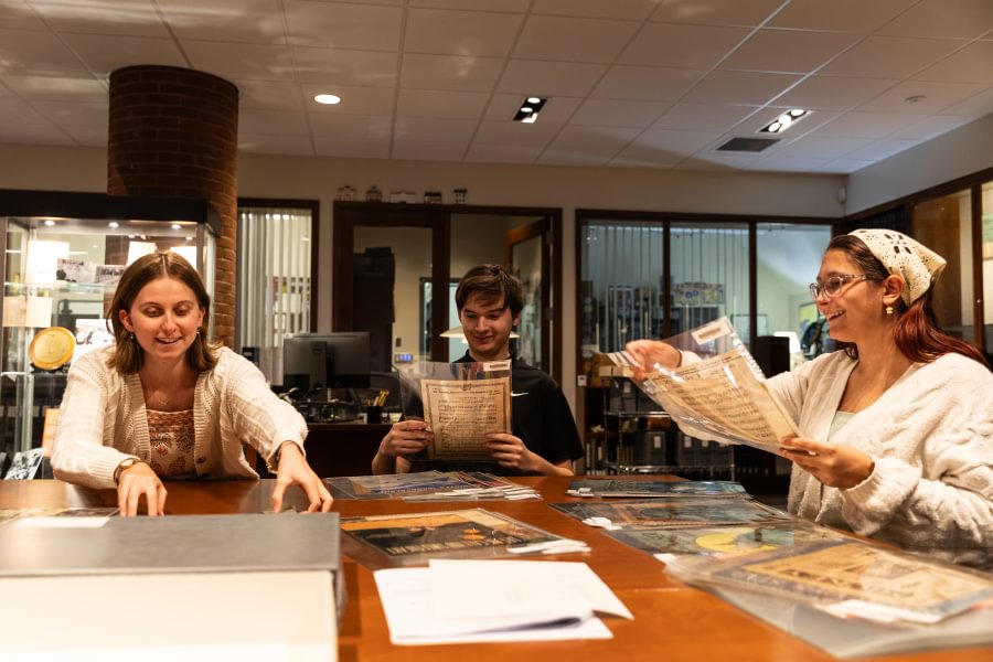 Ainsley Green &rsquo;27, Thomas Geuther &rsquo;29, and Zee Dawson &rsquo;29 explore a collection of sheet music from Special Collections.