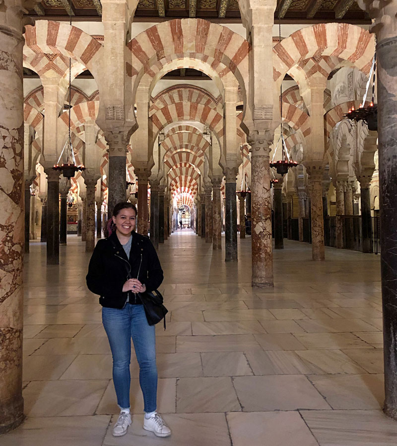 Sidney Caccioppoli in a Spanish building with decorative arches and columns