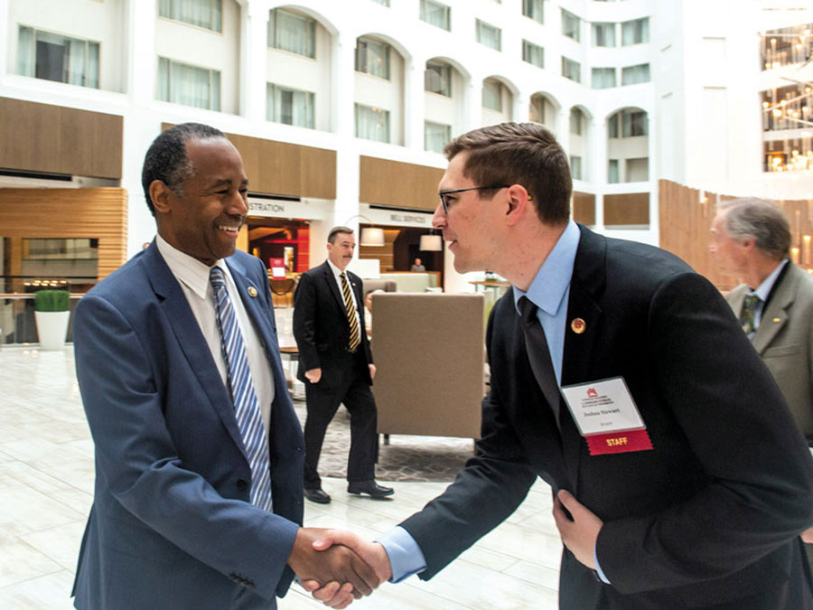 Photo of Josh Stewart and Ben Carson '11 shaking hands